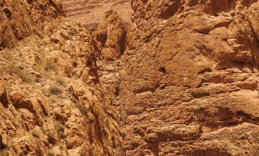 a rocky canyon with a blue sky