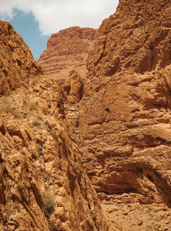 a rocky canyon with a blue sky