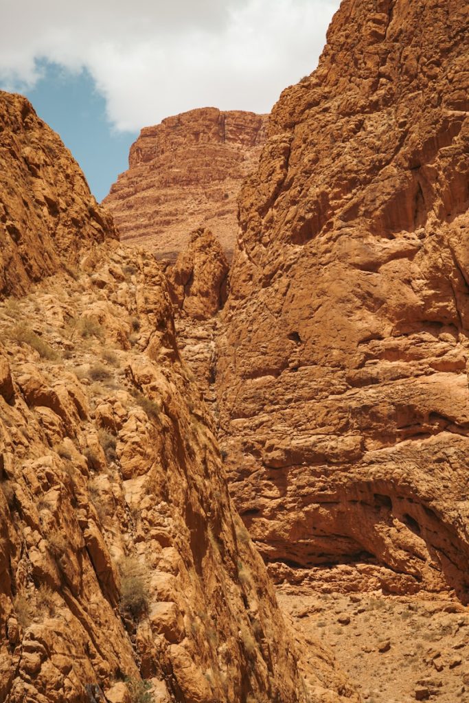 a rocky canyon with a blue sky