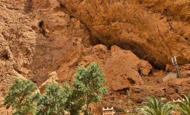 A large rock formation with a building in the middle of it