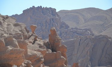 a man standing on top of a rock formation